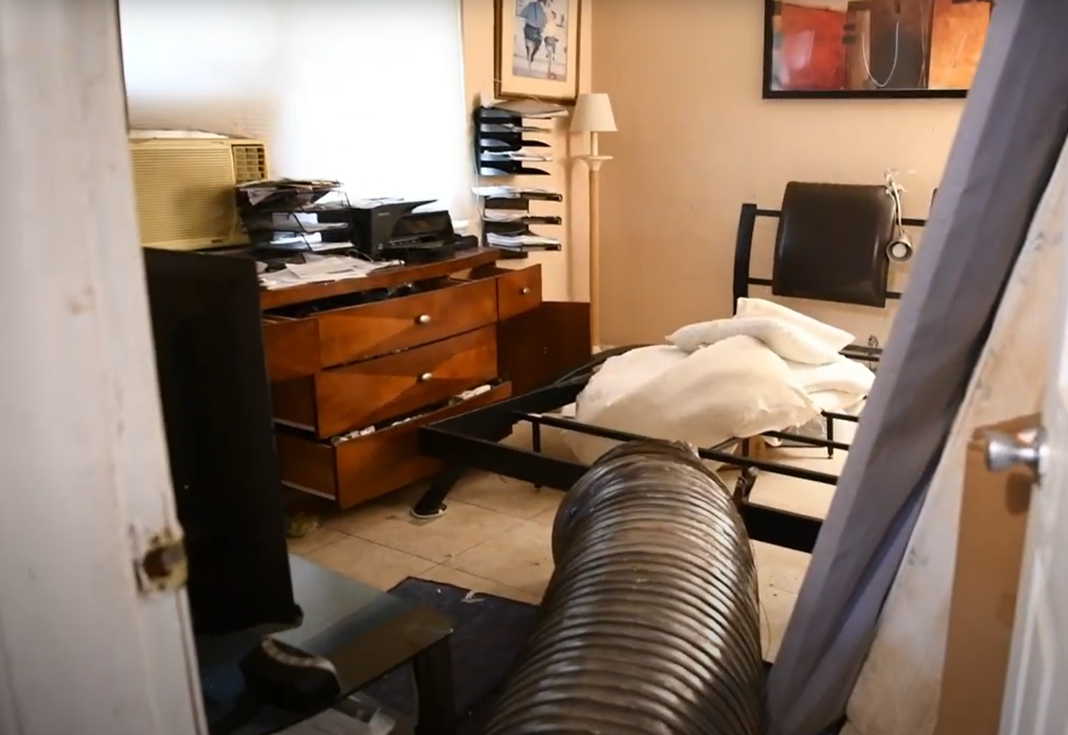 Cluttered bedroom prepared for Pest Control in East Lansing with furniture pulled back for treatment access.